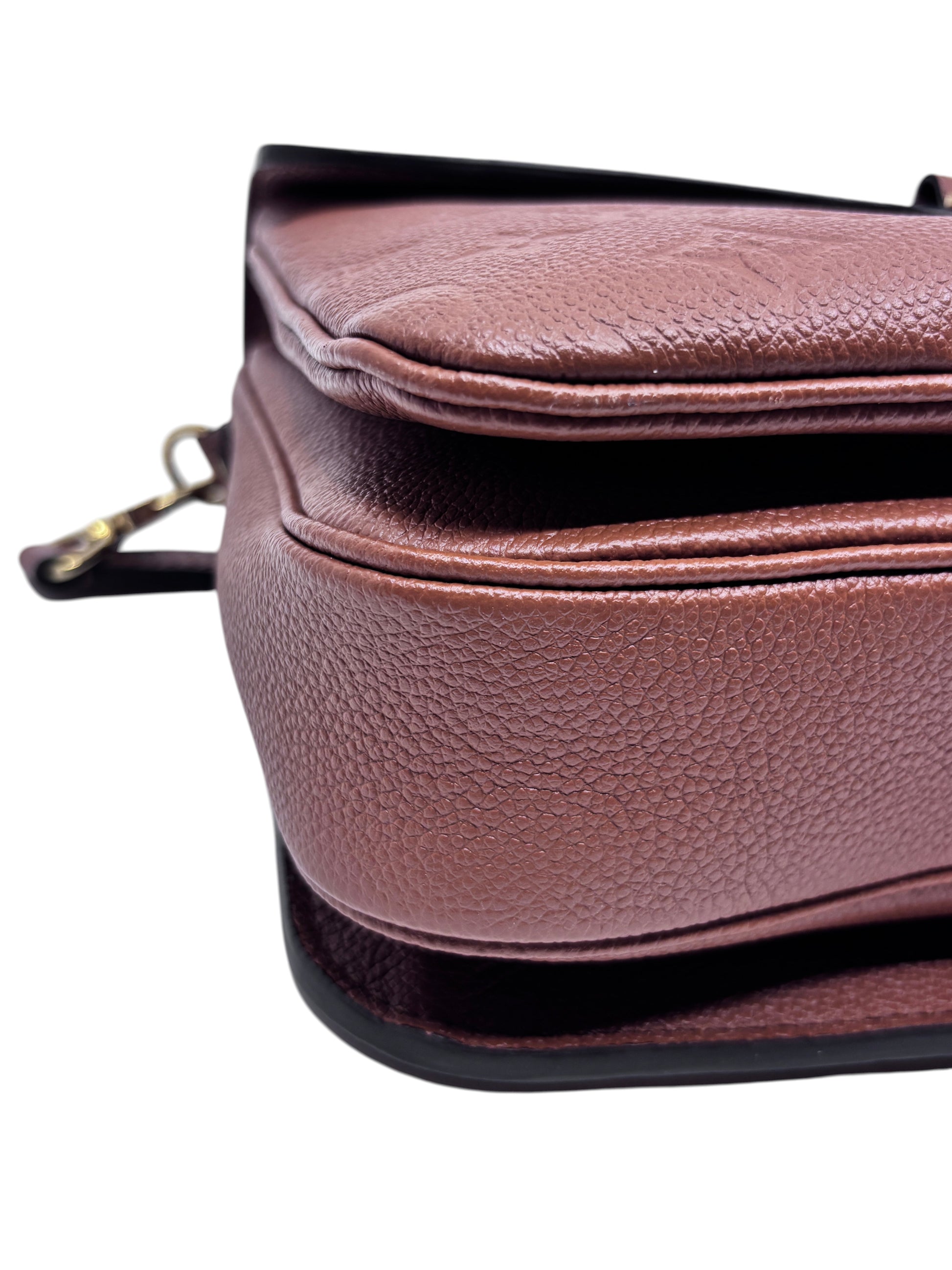 Posh Purse Co. Louis Vuitton Pochette Metis handbag side view showing brown textured leather and gold-tone hardware.