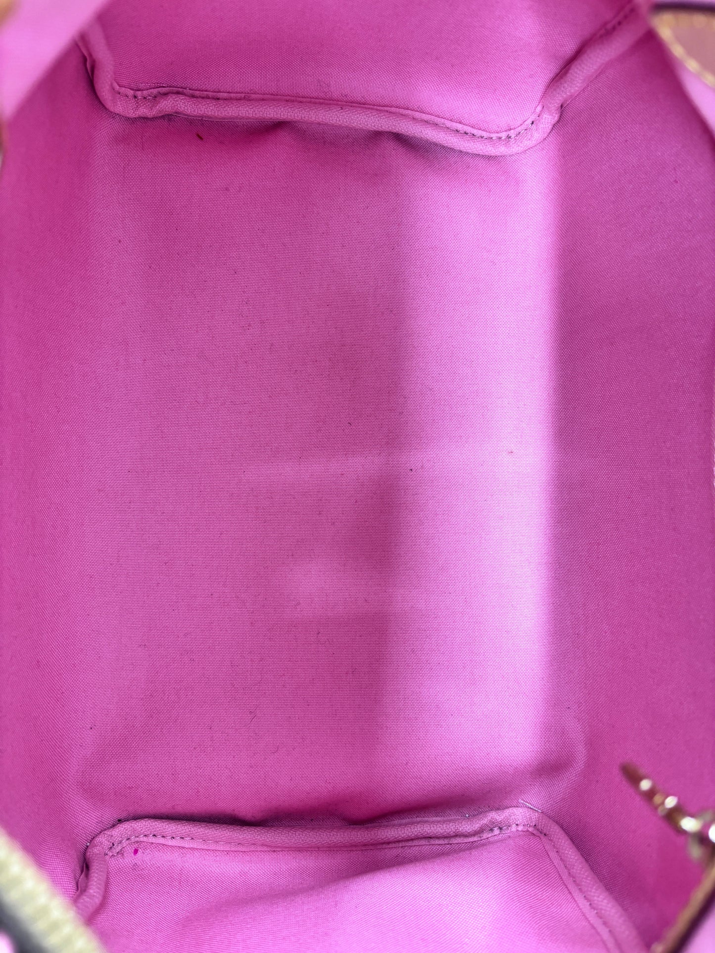 Interior of Posh Purse Co Louis Vuitton Speedy 30 Jungle Dots bag featuring vibrant sugar pink fabric lining