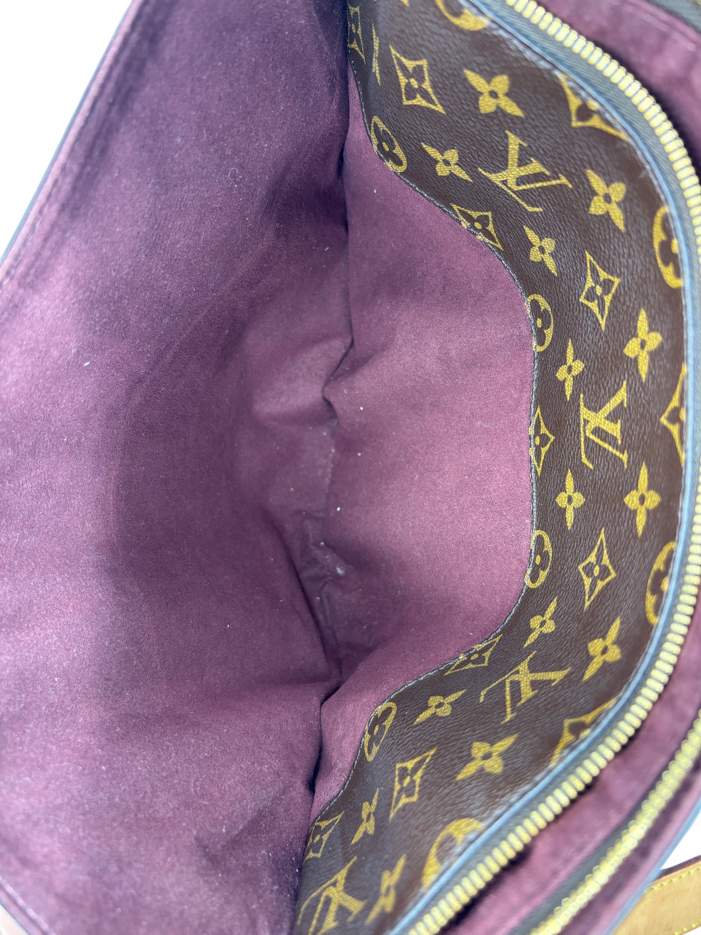 Interior view of Posh Purse Co. Louis Vuitton Flower Zipped Tote featuring dark purple lining and Monogram canvas.