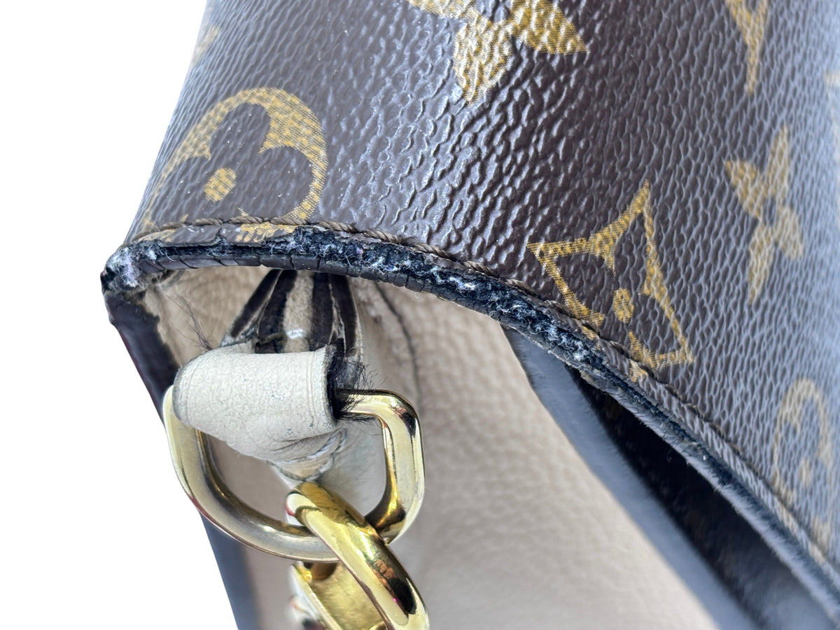 Close-up of Posh Purse Co Louis Vuitton Vaugirard bag showing monogram canvas edge wear and gold-tone hardware detail.