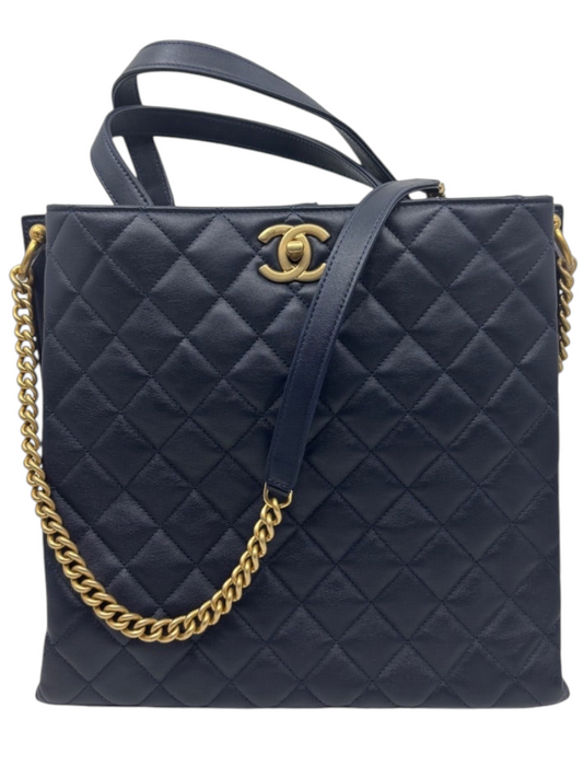 Posh Purse Co. navy blue quilted leather Chanel tote bag with gold hardware and chain strap.