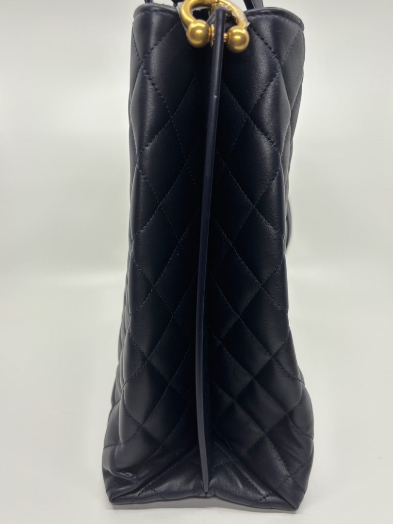 Posh Purse Co. navy blue quilted leather Chanel tote bag with gold hardware.
