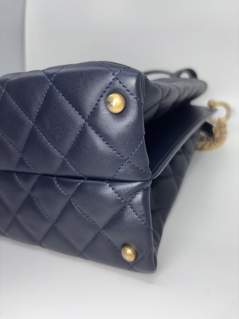 Posh Purse Co. navy blue quilted leather Chanel tote bag with gold hardware.