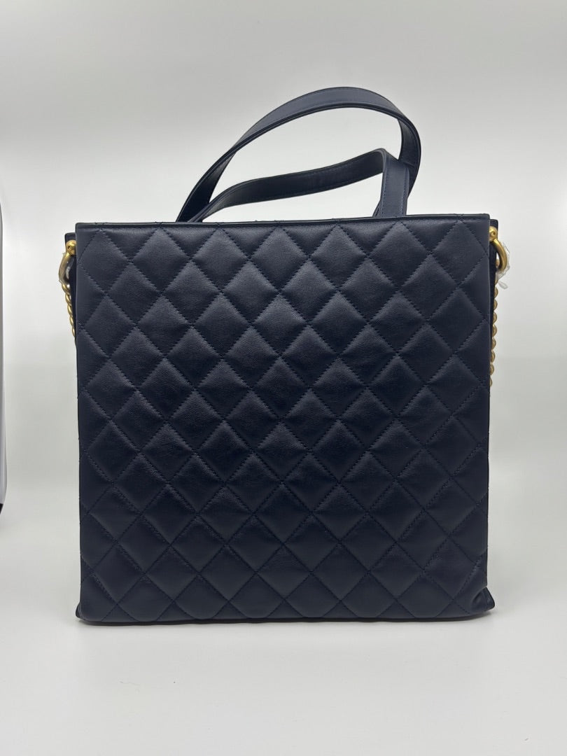 Posh Purse Co. navy blue quilted leather Chanel tote bag with gold hardware and top handles.