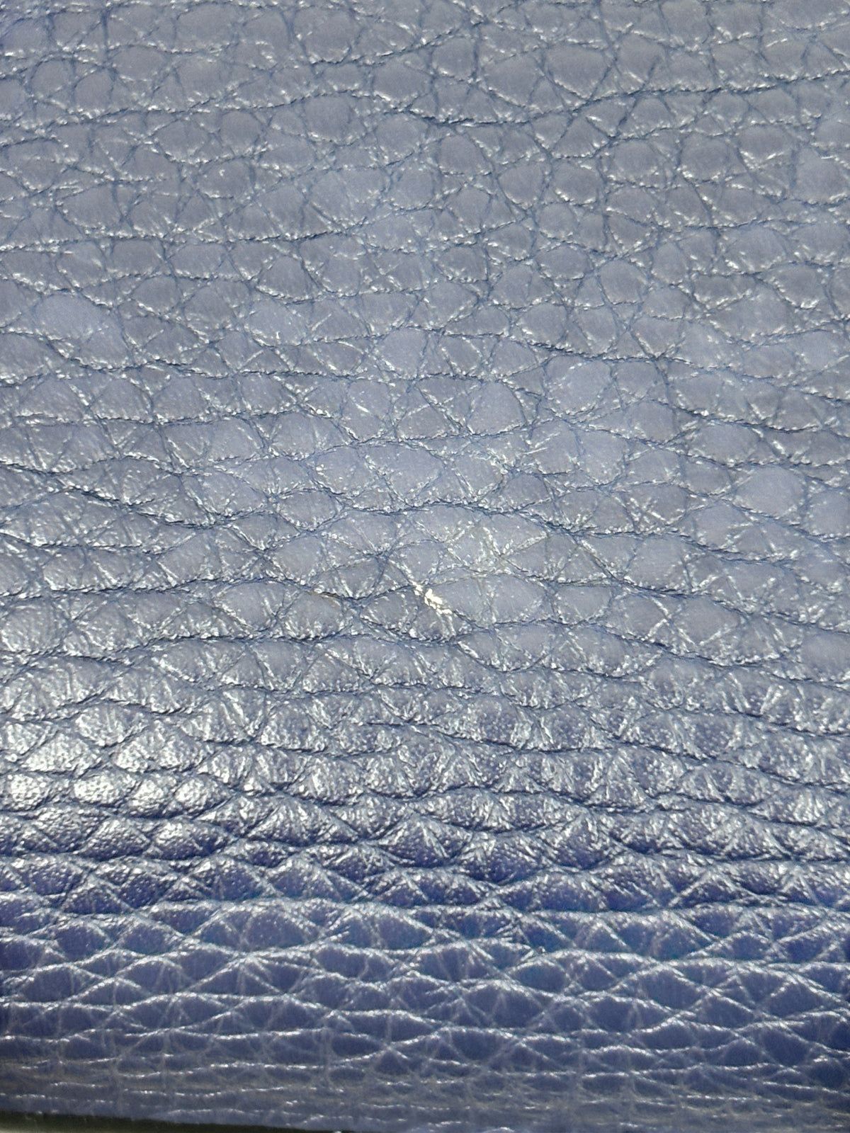 Close-up of navy blue grained calfskin leather texture on a Posh Purse Co Valentino Rockstud tote bag