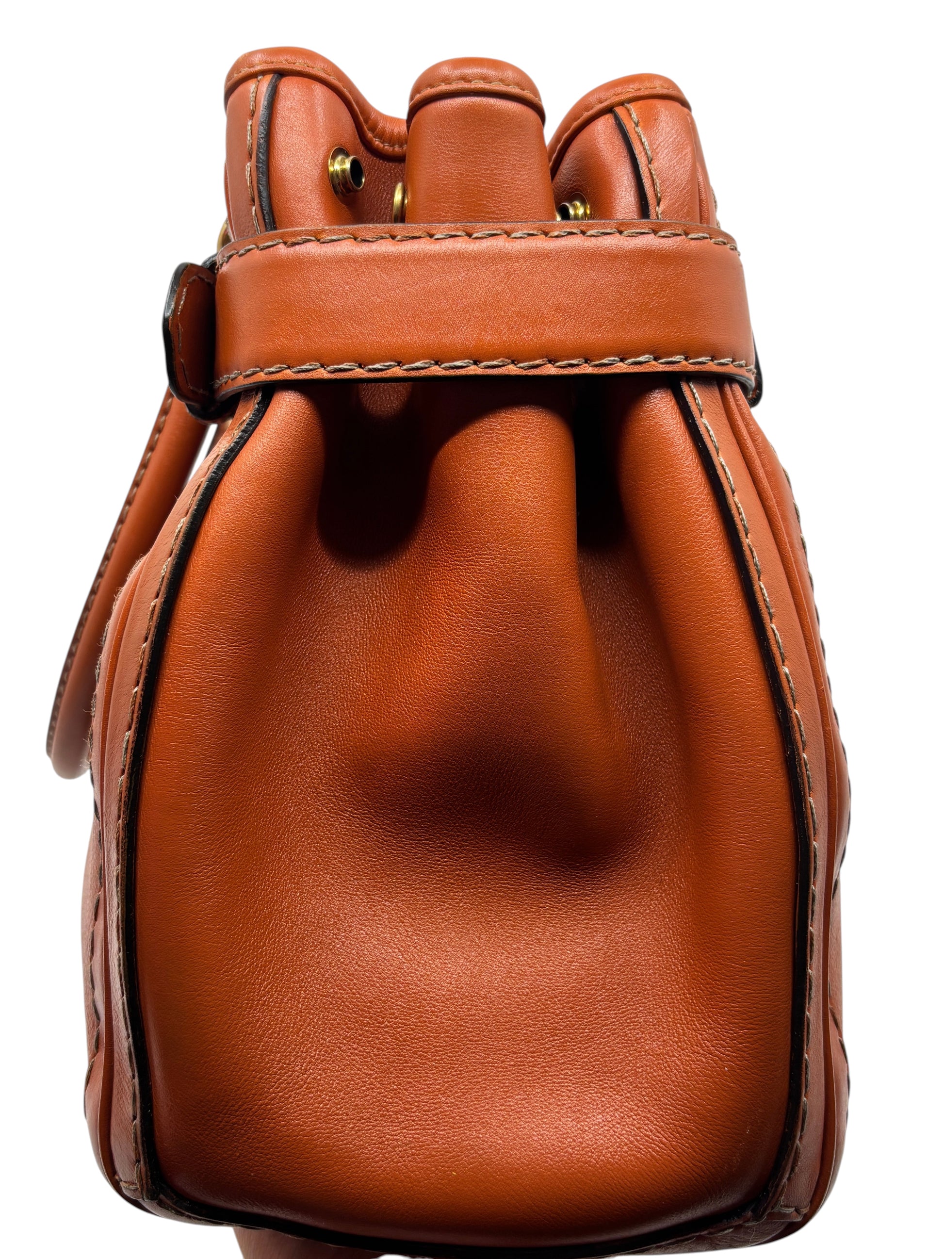 Posh Purse Co. preloved orange leather Gucci GG Running tote bag side profile showing smooth texture and stitching.