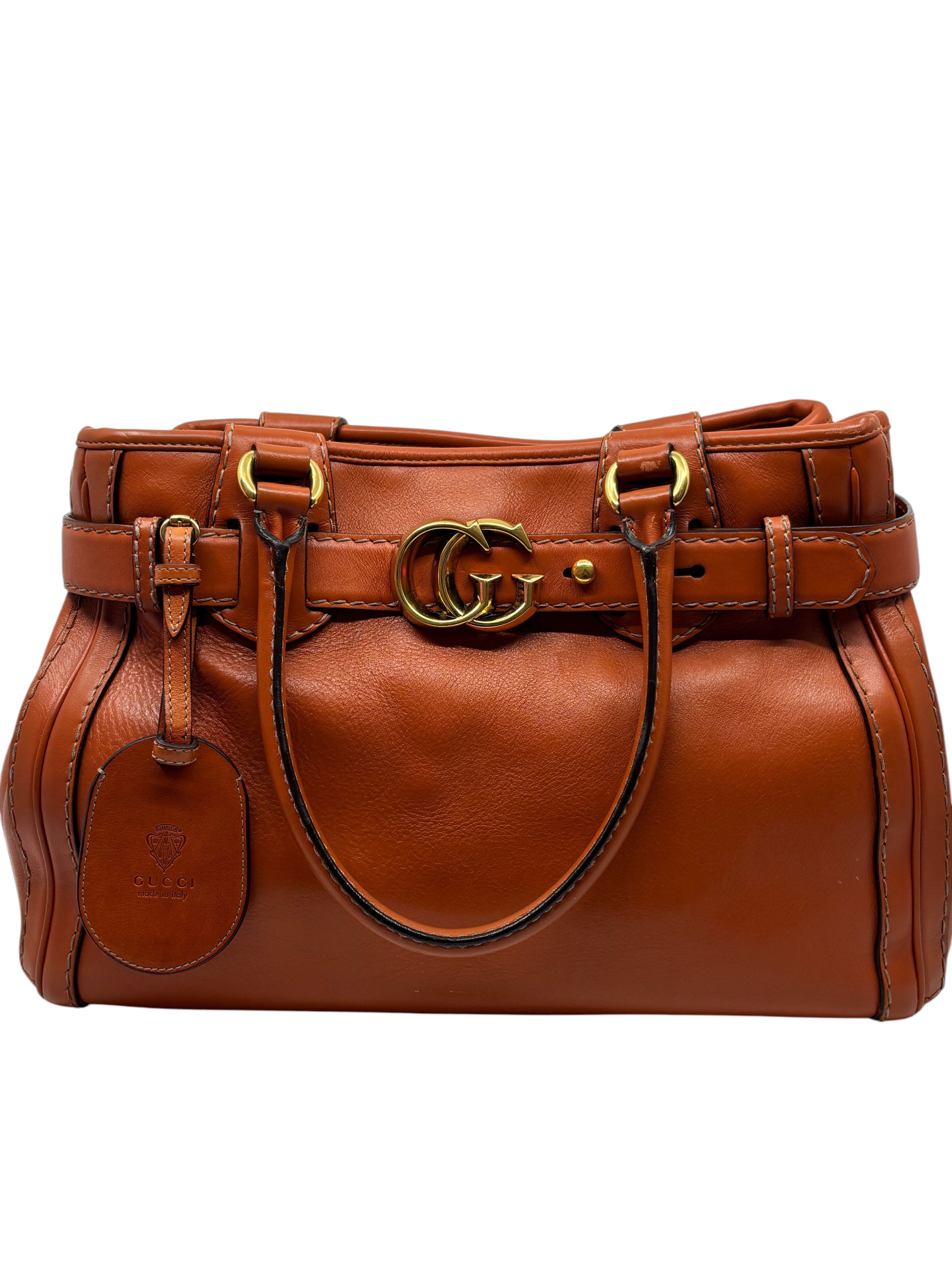 Posh Purse Co. preloved orange leather Gucci GG Running tote bag with gold-tone hardware and luggage tag.