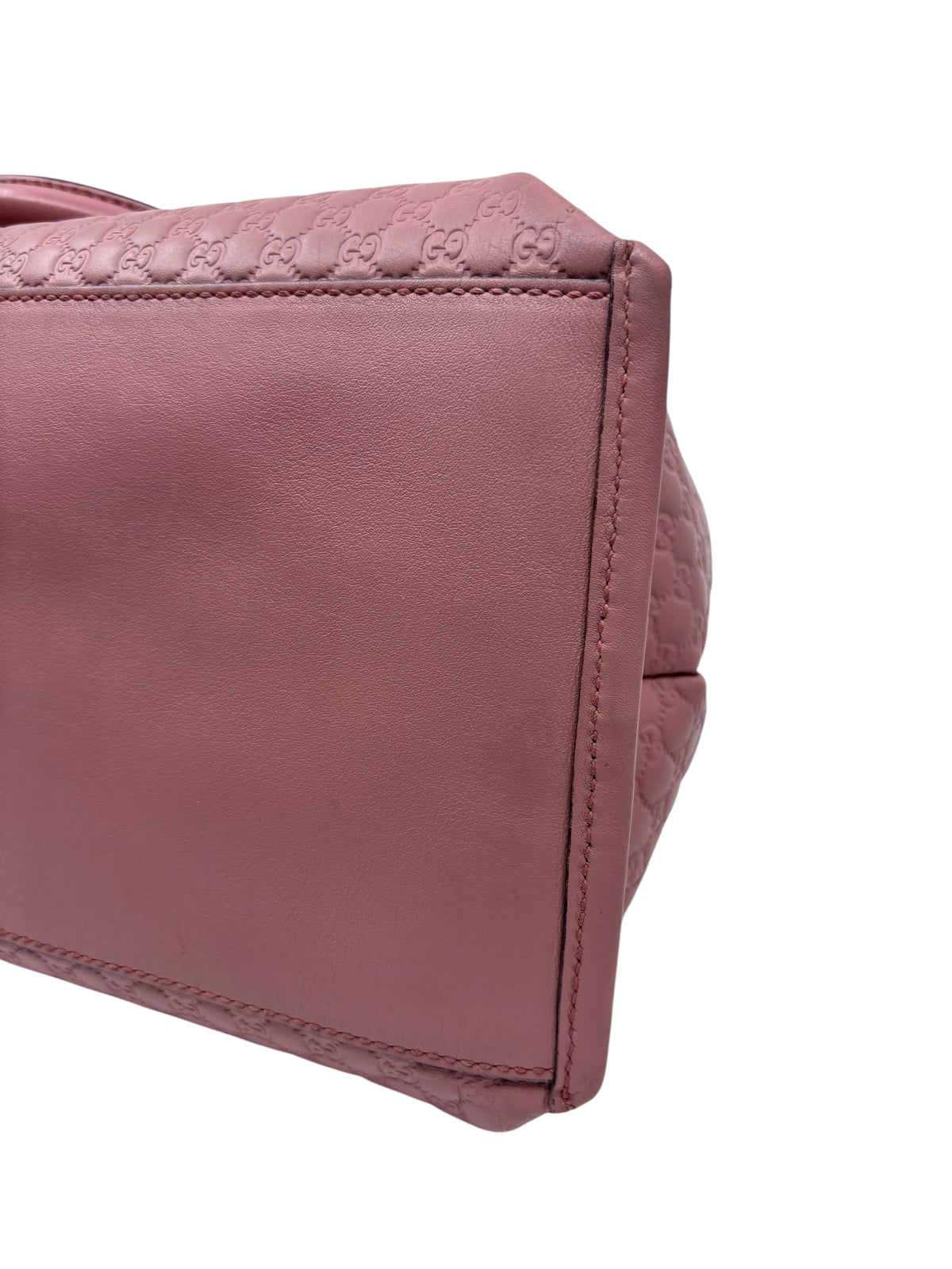 Posh Purse Co. pink Gucci Micro Guccissima leather handbag side view showing embossed logo detail