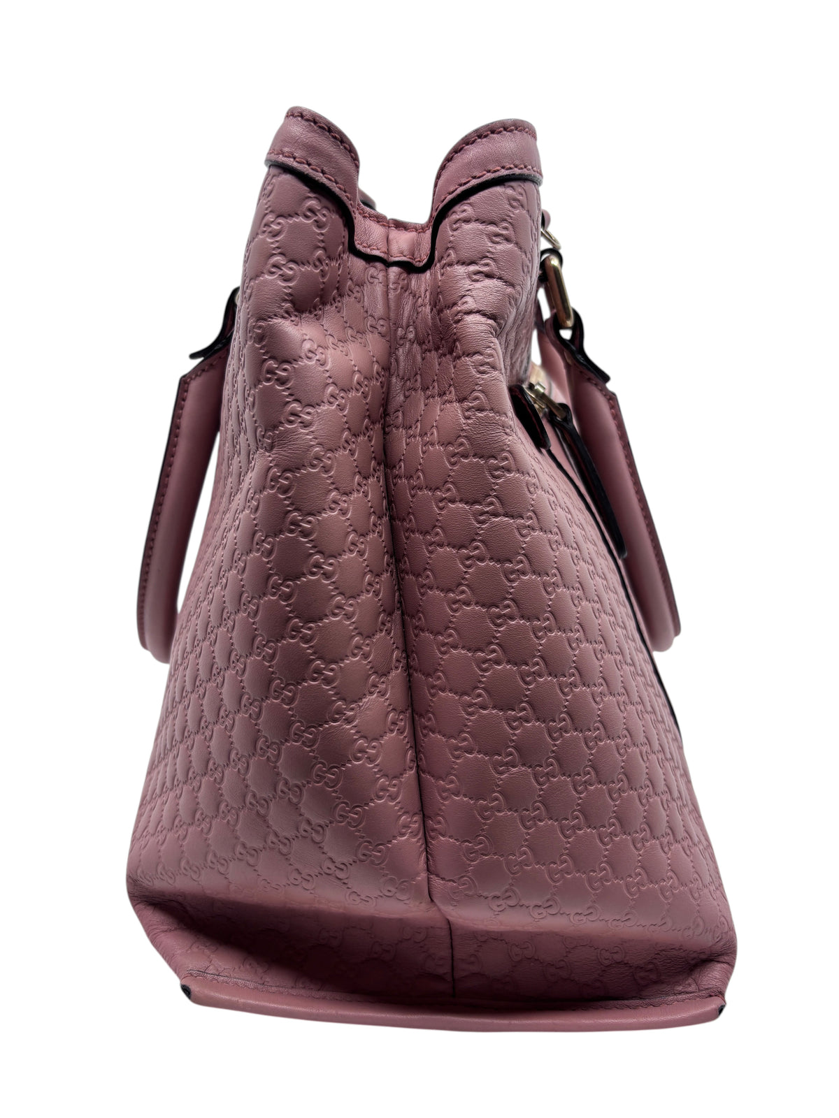 Side view of a pink Posh Purse Co. Gucci Micro Guccissima leather top handle bag with embossed monogram pattern.