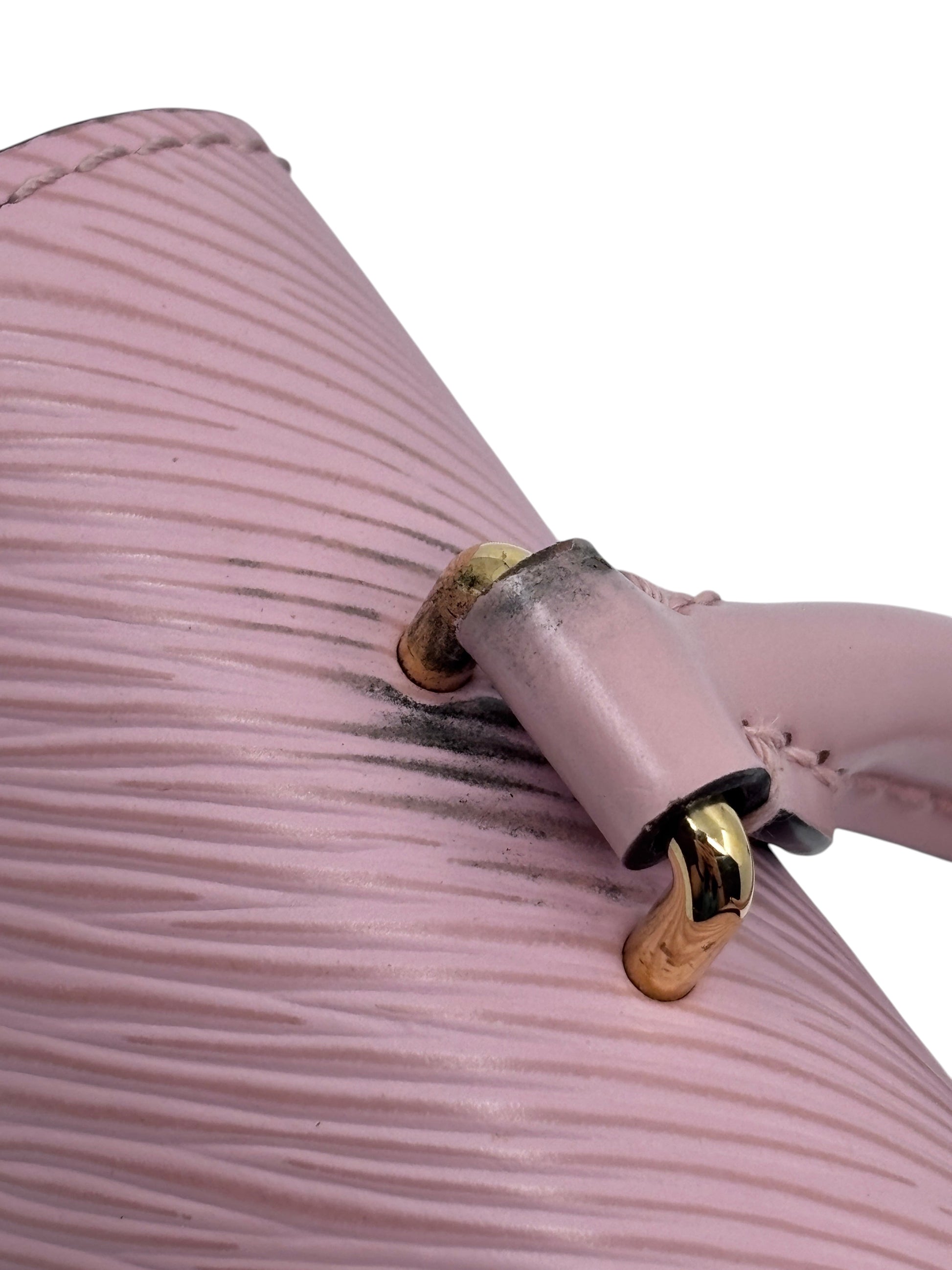 Posh Purse Co. pink Louis Vuitton Locky handbag showing wear and dark marks near the gold hardware handle attachment