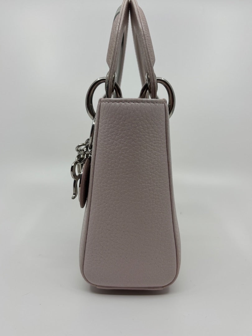 Side view of a pink Mini Lady Dior handbag with silver hardware, available at Posh Purse Co.