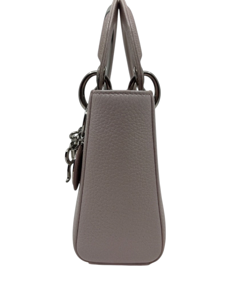 Side view of a pink Mini Lady Dior handbag with silver hardware, available at Posh Purse Co.