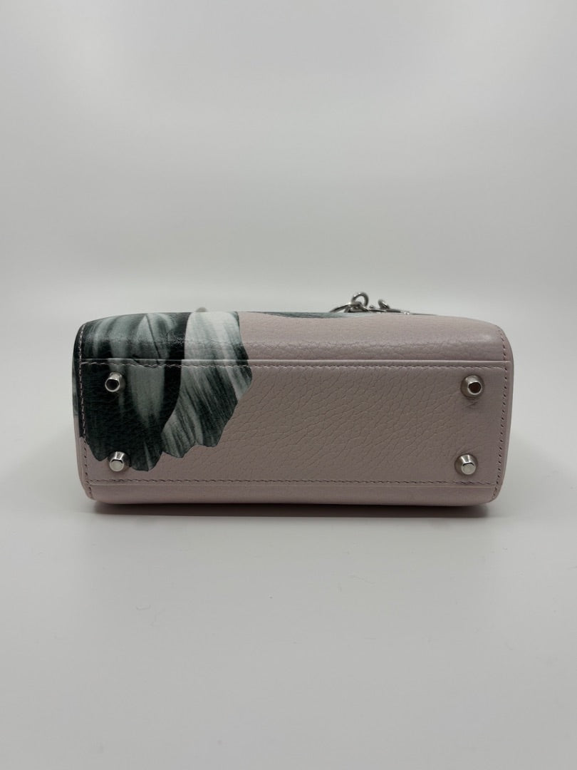 Base of a pink Dior Mini Lady Dior bag with floral print and silver protective feet, available at Posh Purse Co.