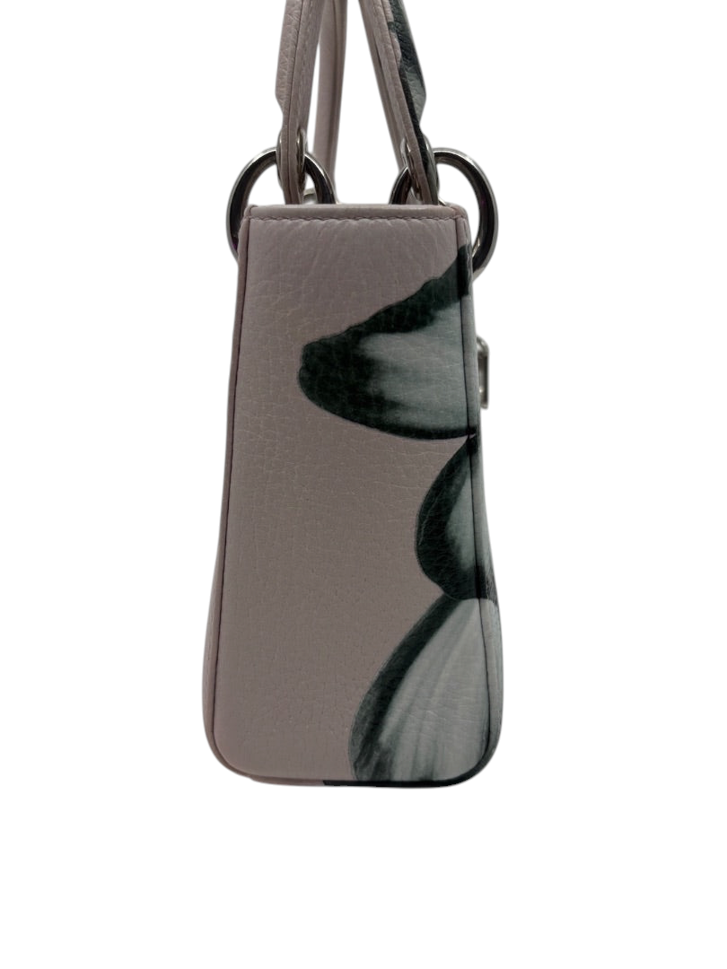 Side view of a preloved pink floral Mini Lady Dior bag with silver hardware, sold by Posh Purse Co.