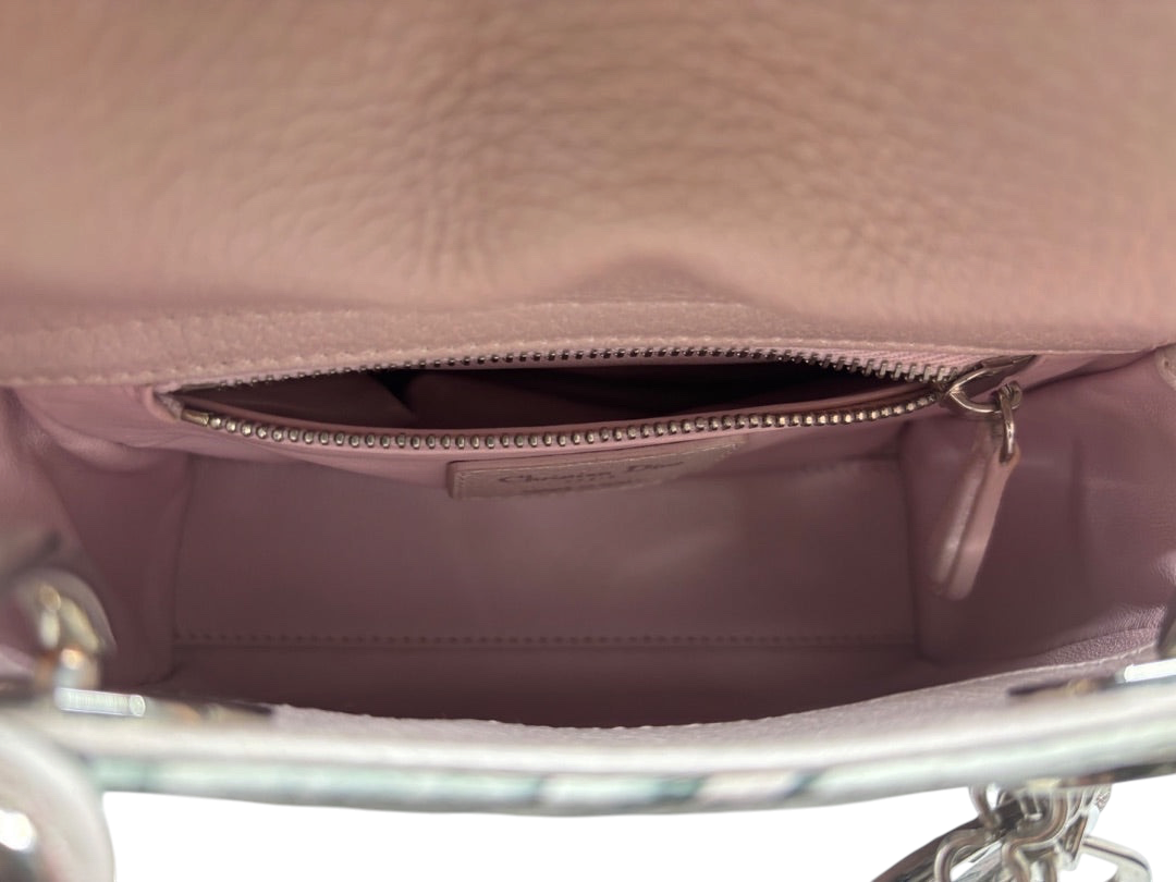 Interior of a preloved pink Mini Lady Dior bag with a zippered pocket and Christian Dior label from Posh Purse Co.