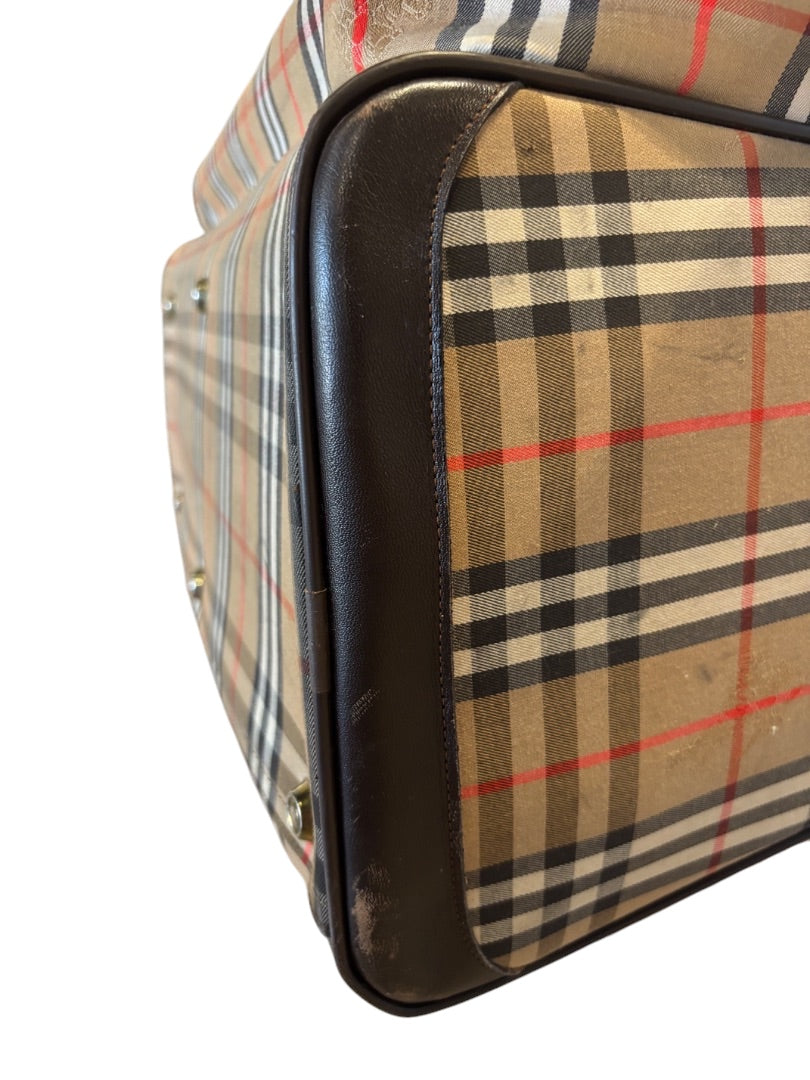 Posh Purse Co. classic plaid duffle bag in beige, black, red, and white with dark brown leather trim and handles. Spacious weekend bag.