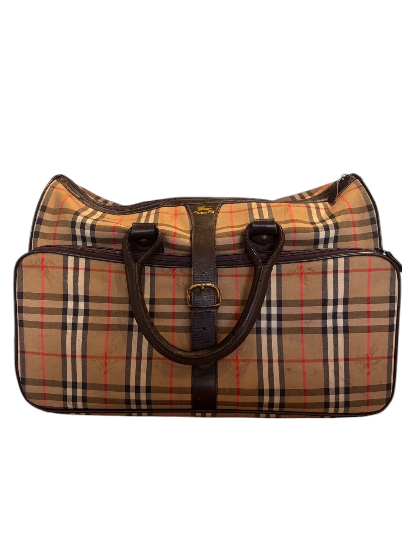Posh Purse Co. classic plaid duffle bag with dark brown leather handles and trim. Beige, black, red, and white plaid pattern.