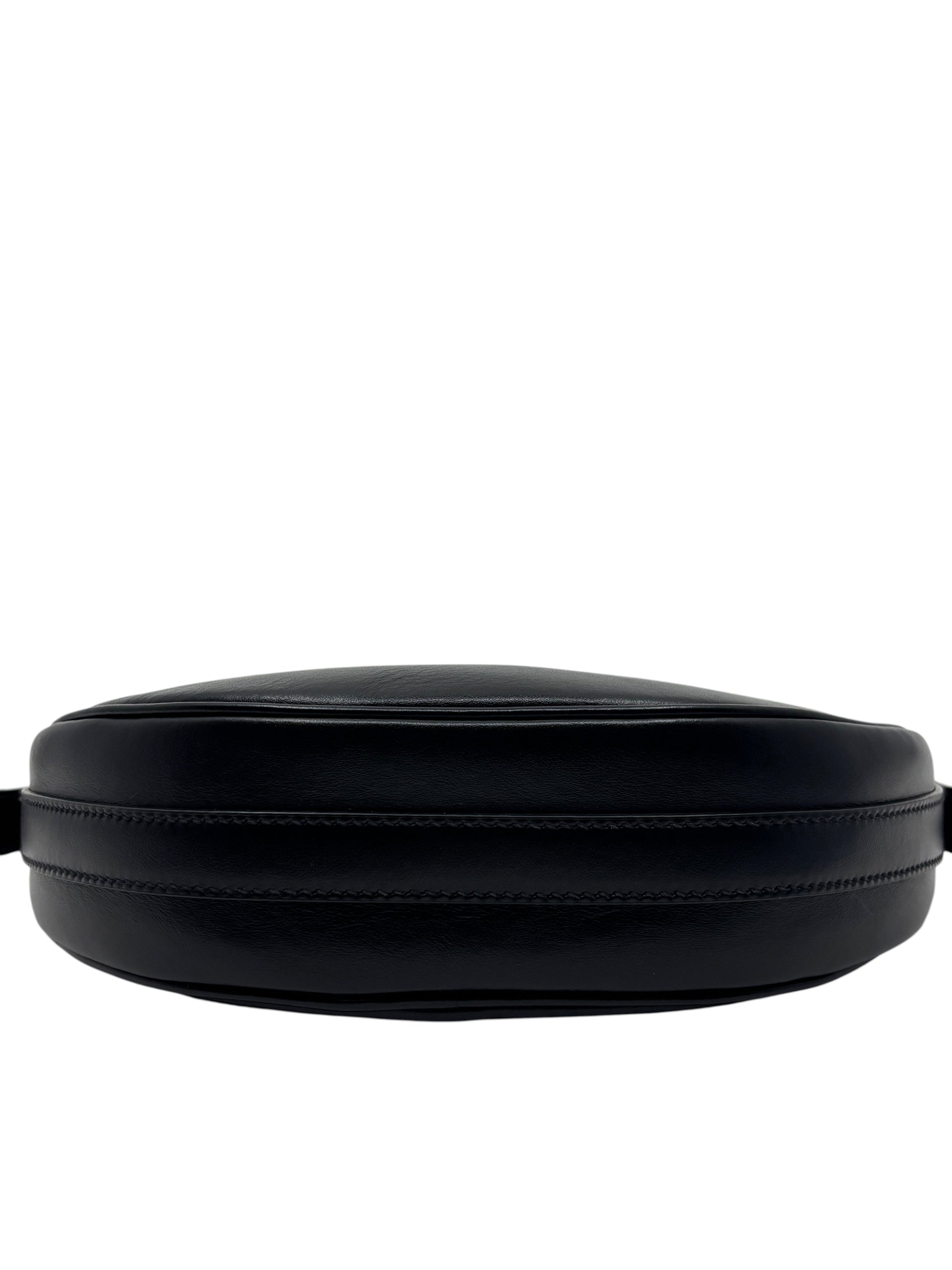 Posh Purse Co. black leather Prada Arqué shoulder bag showing the curved base and detailed stitching.