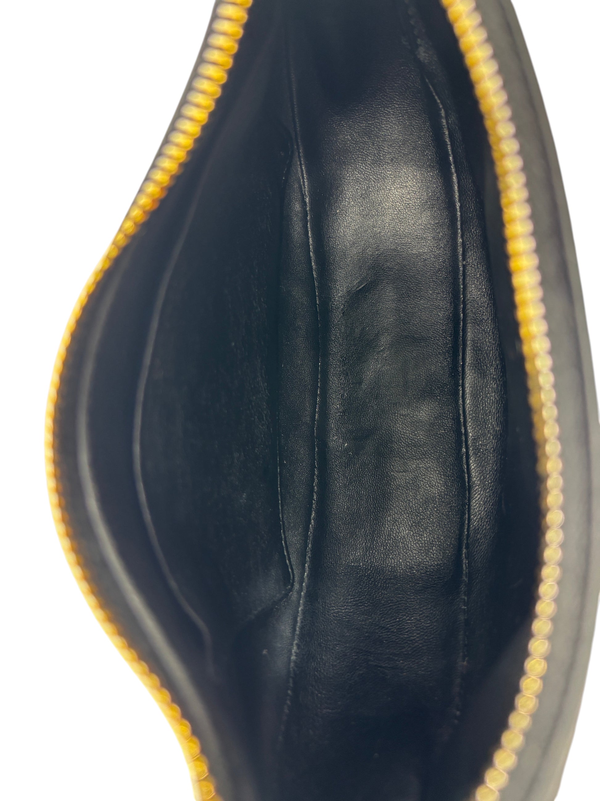 Interior of Posh Purse Co. black leather Prada Arque shoulder bag showing smooth lining and gold zipper detail