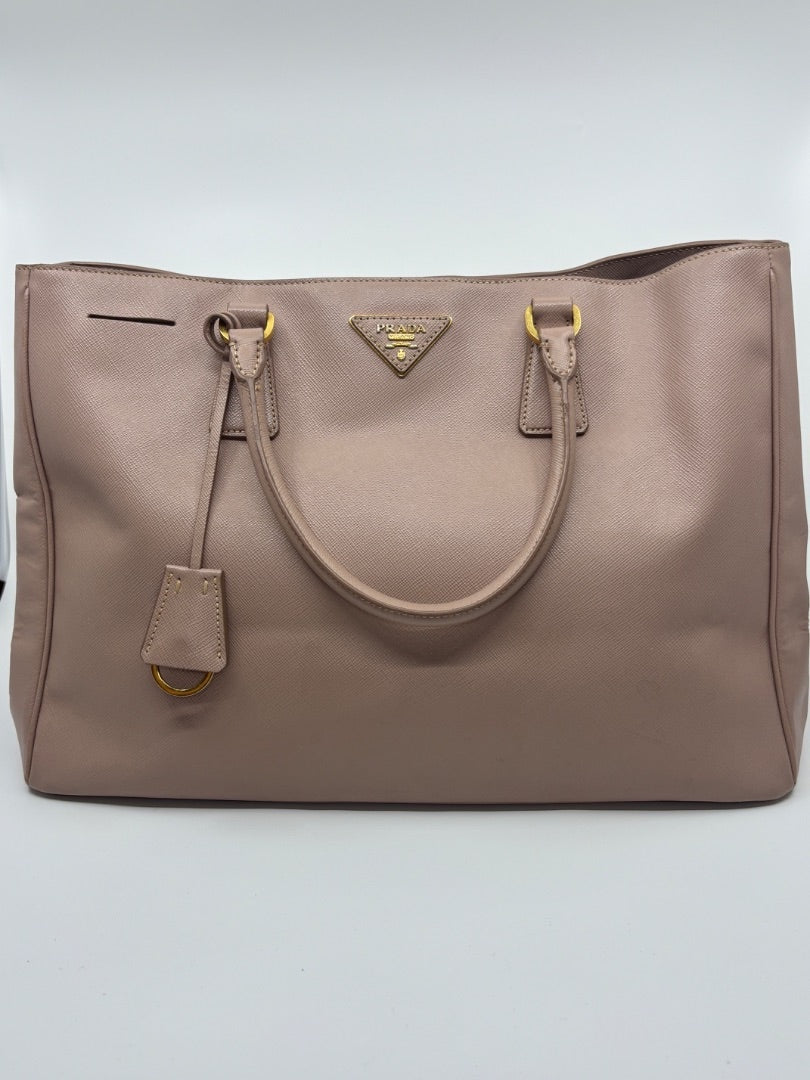 Posh Purse Co. large blush pink Saffiano leather Prada tote bag with gold hardware and signature triangle logo.