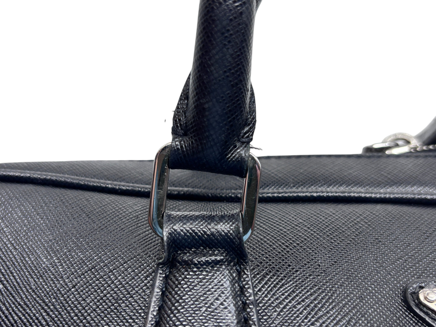 Posh Purse Co black Prada Saffiano leather briefcase handle detail showing textured leather and silver hardware