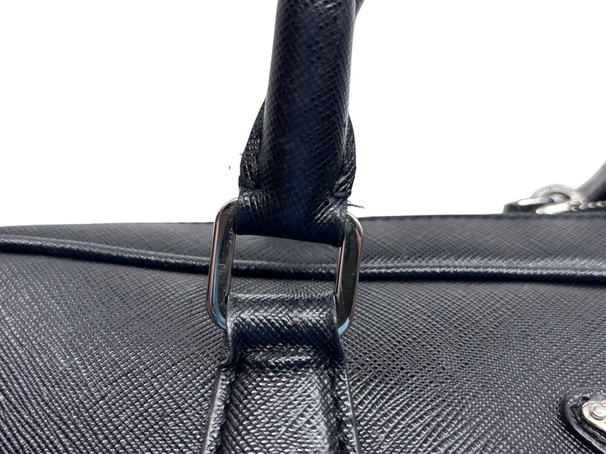 Posh Purse Co black Prada Saffiano leather briefcase handle detail showing textured leather and silver hardware