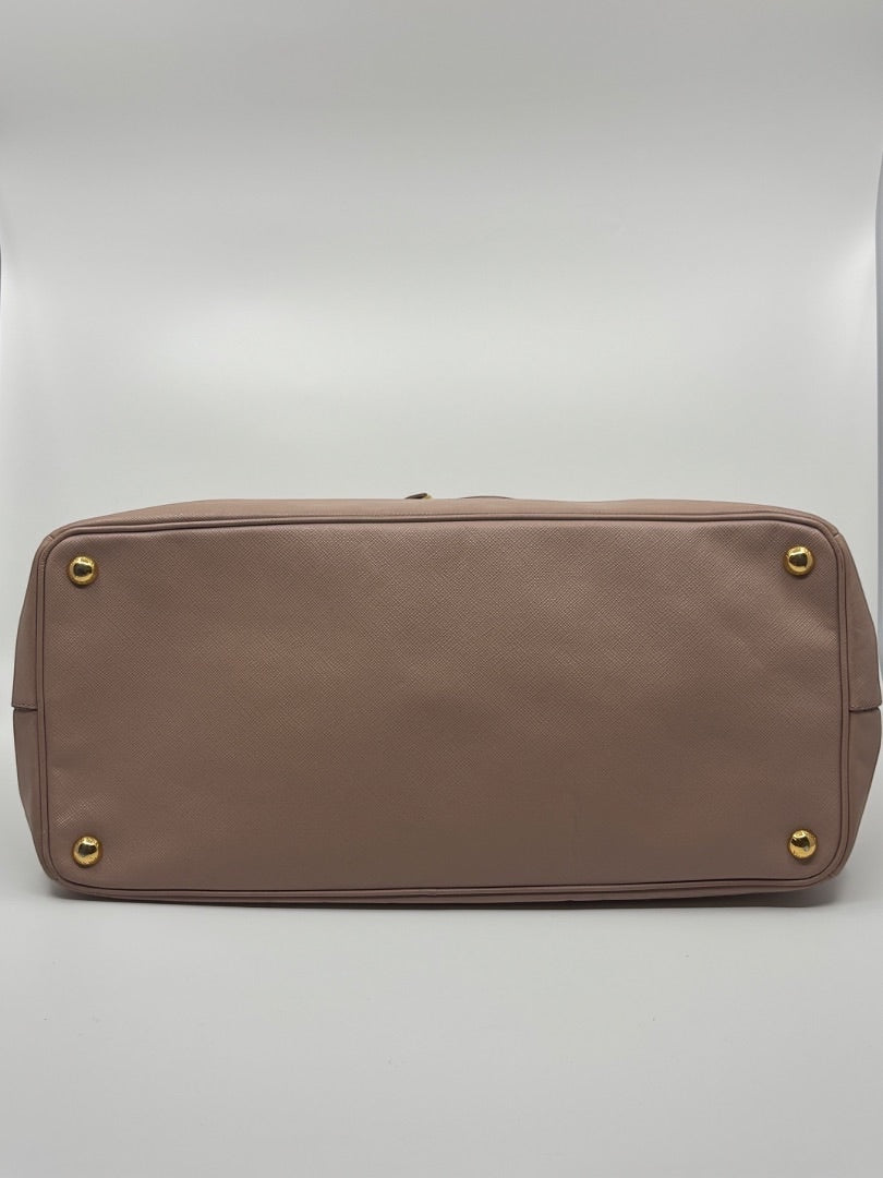 Posh Purse Co. Large Blush Prada Tote with gold hardware and protective feet.