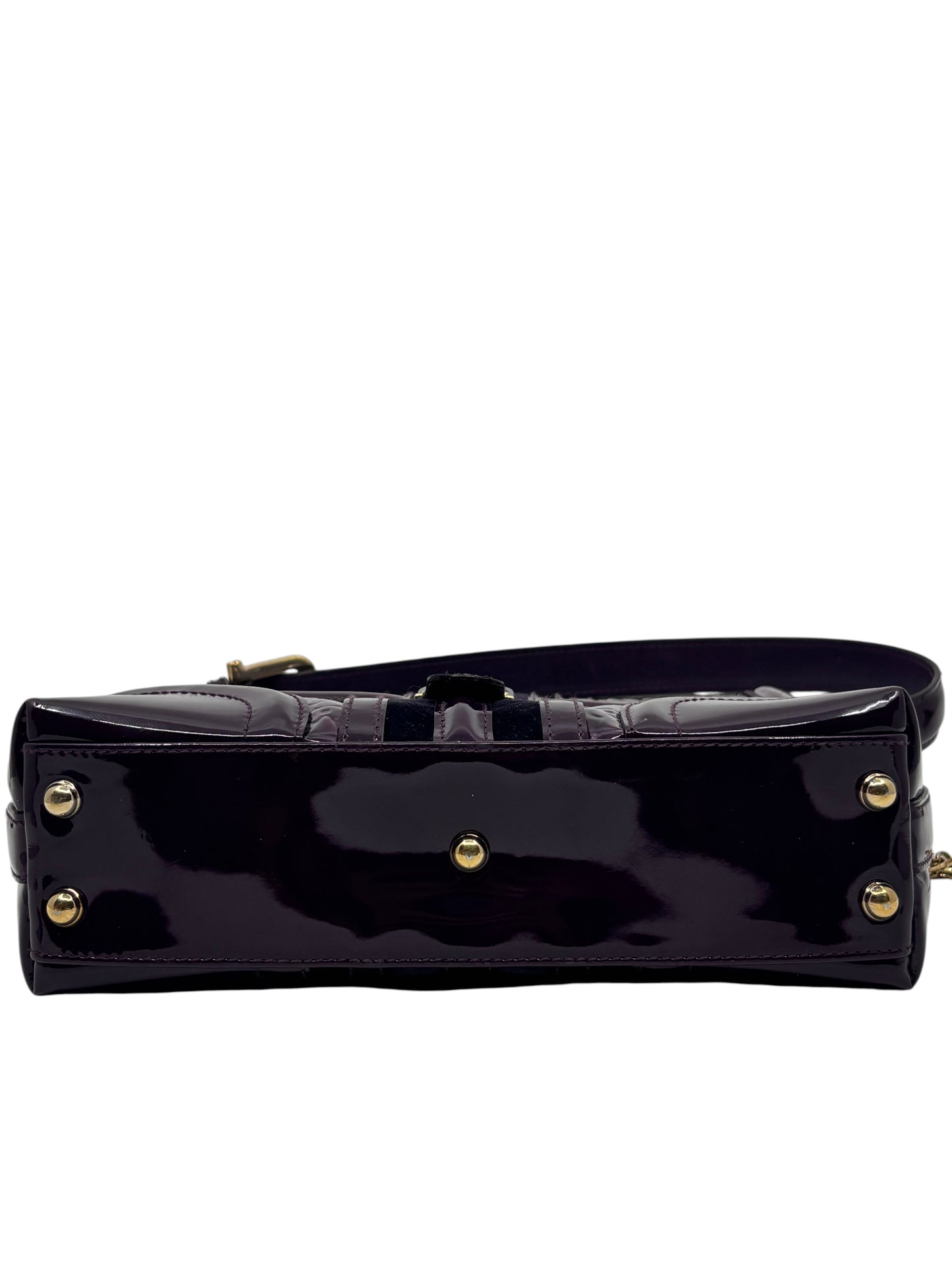 Posh Purse Co. preloved purple patent leather Gucci Horsebit Treasure bag base with gold-tone protective feet.
