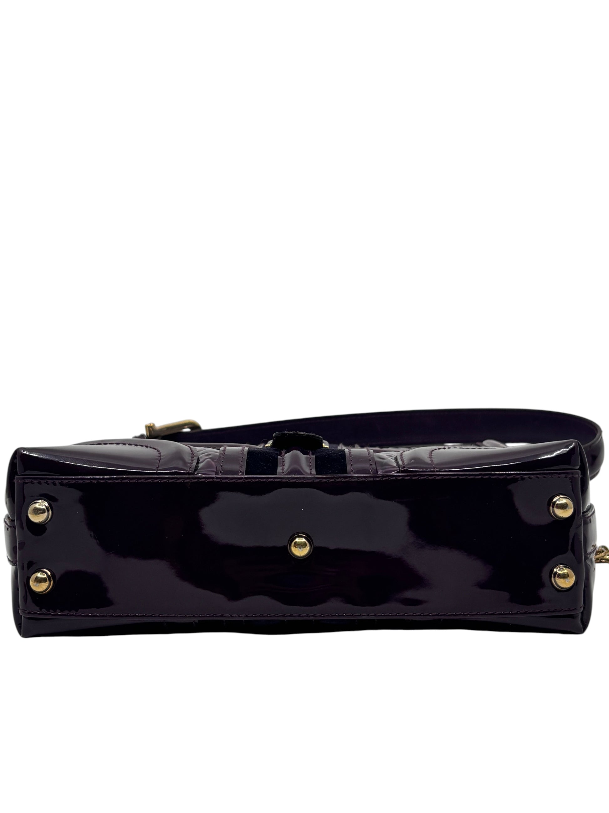 Posh Purse Co. preloved purple patent leather Gucci Horsebit Treasure bag base with gold-tone protective feet.