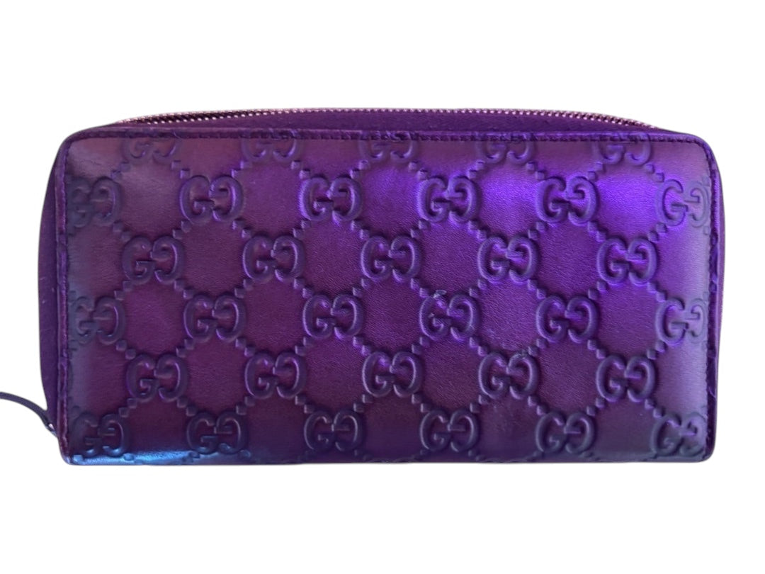 Posh Purse Co. purple Guccissima embossed leather zip-around wallet with GG monogram pattern.