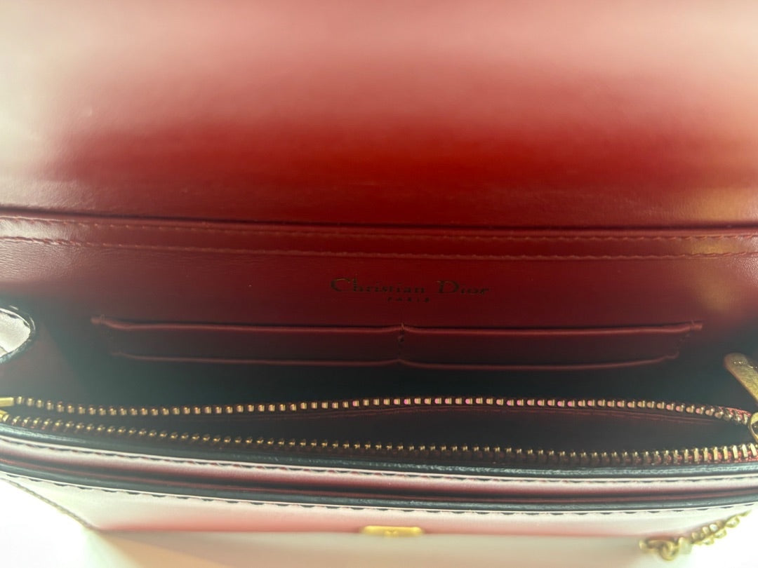 Interior of a red leather Dior J'adior crossbody bag with Christian Dior branding, available at Posh Purse Co.