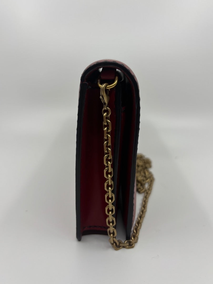Side profile of a red Dior J'adior crossbody bag with gold chain strap, sold by Posh Purse Co.