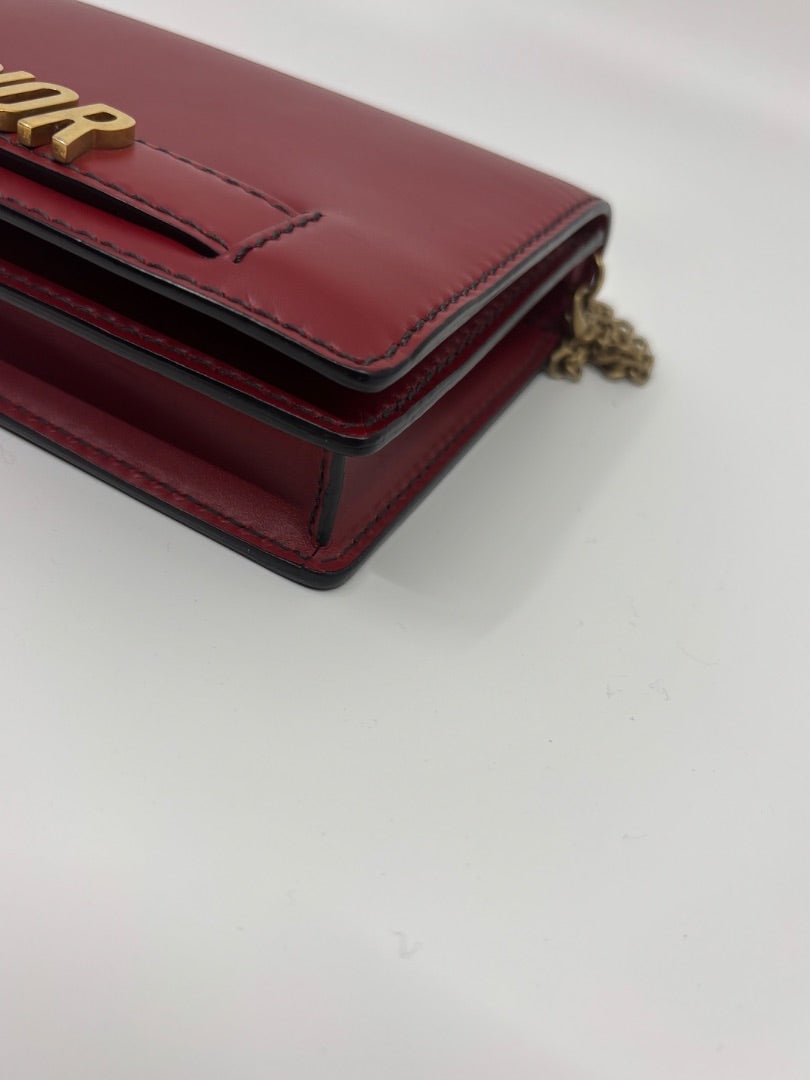 Posh Purse Co red leather Dior J'adior crossbody bag with gold-tone hardware and structured silhouette.