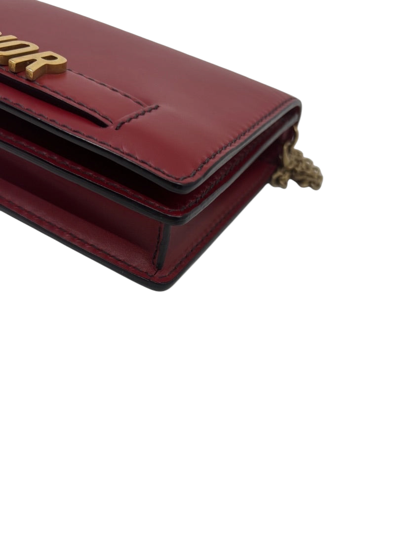 Posh Purse Co red leather Dior J'adior crossbody bag with gold-tone hardware and structured silhouette.