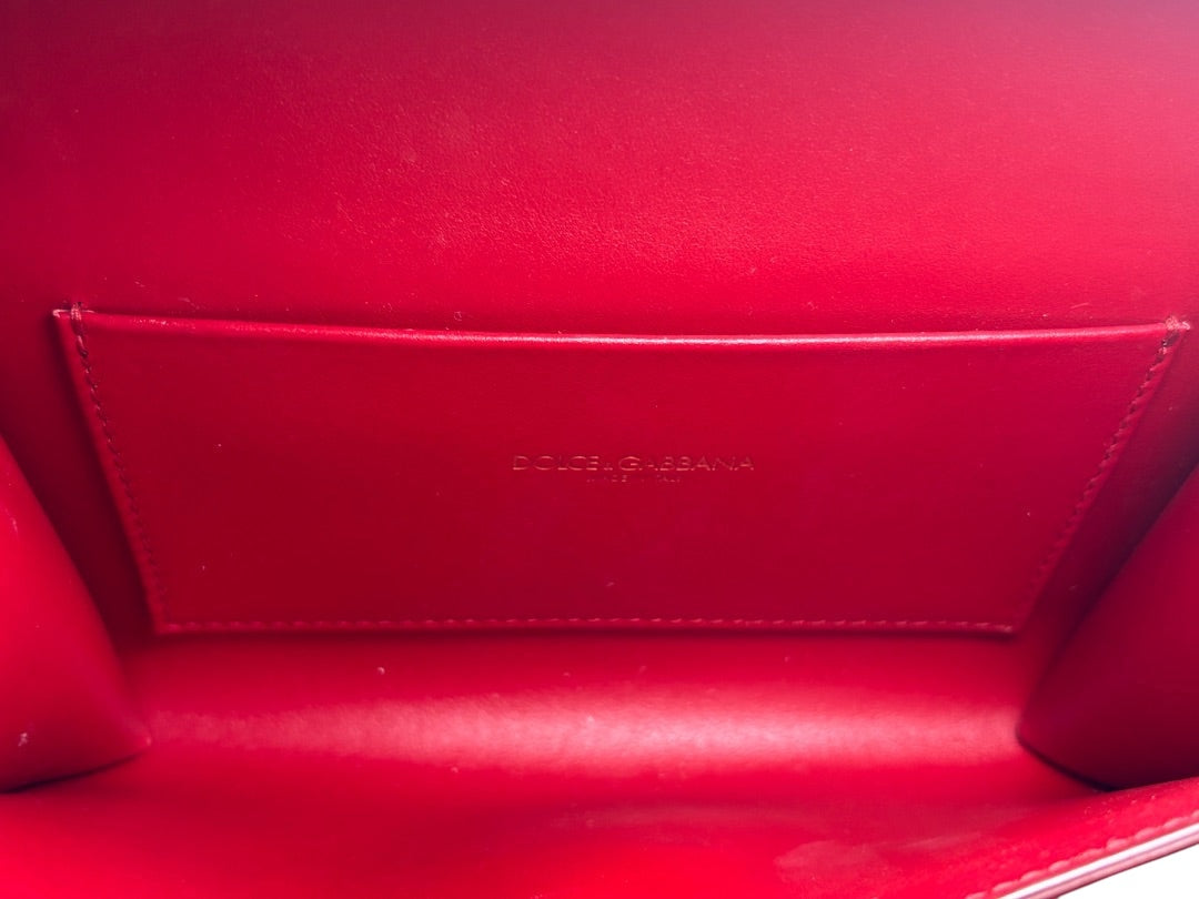 Posh Purse Co. red leather Dolce & Gabbana Devotion belt bag interior with embossed logo and card slot.