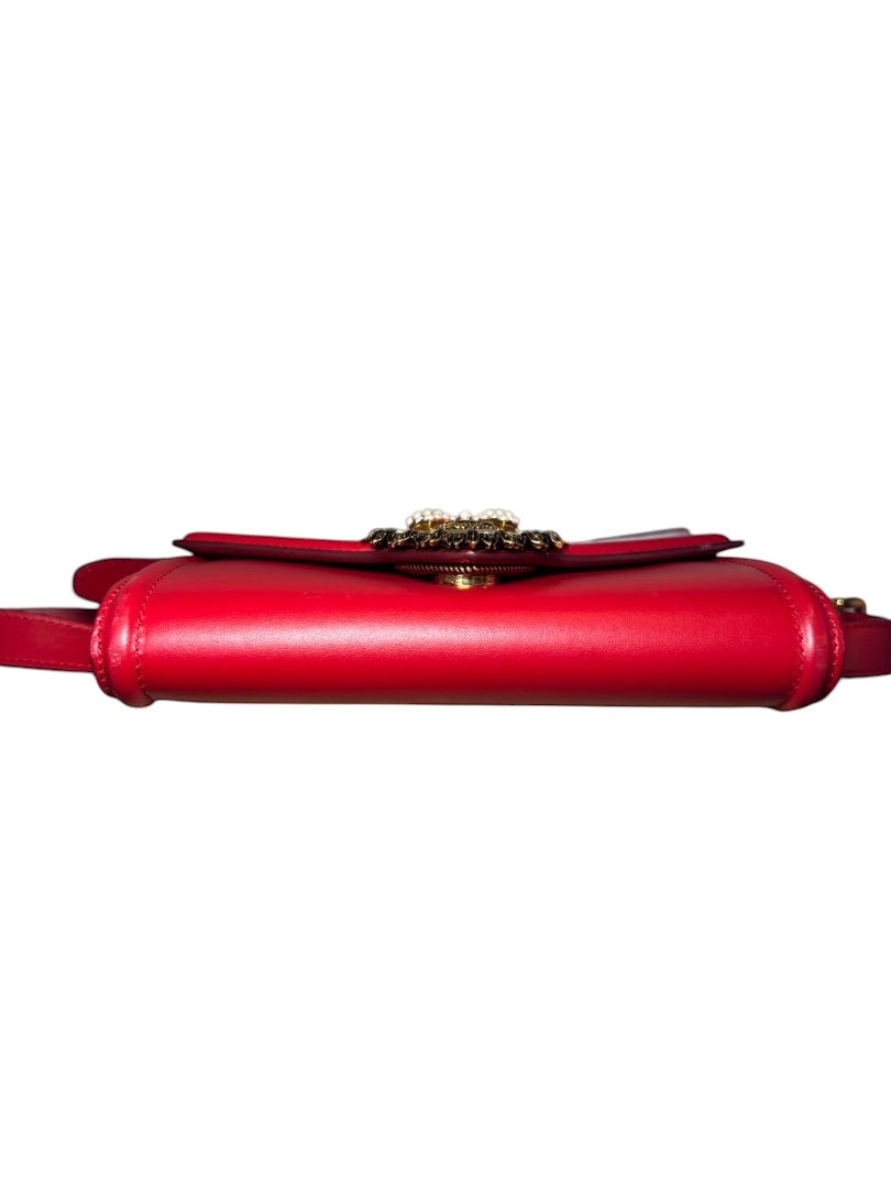 Posh Purse Co. red leather Dolce & Gabbana Devotion belt bag with gold-tone hardware and pearl-embellished heart emblem.