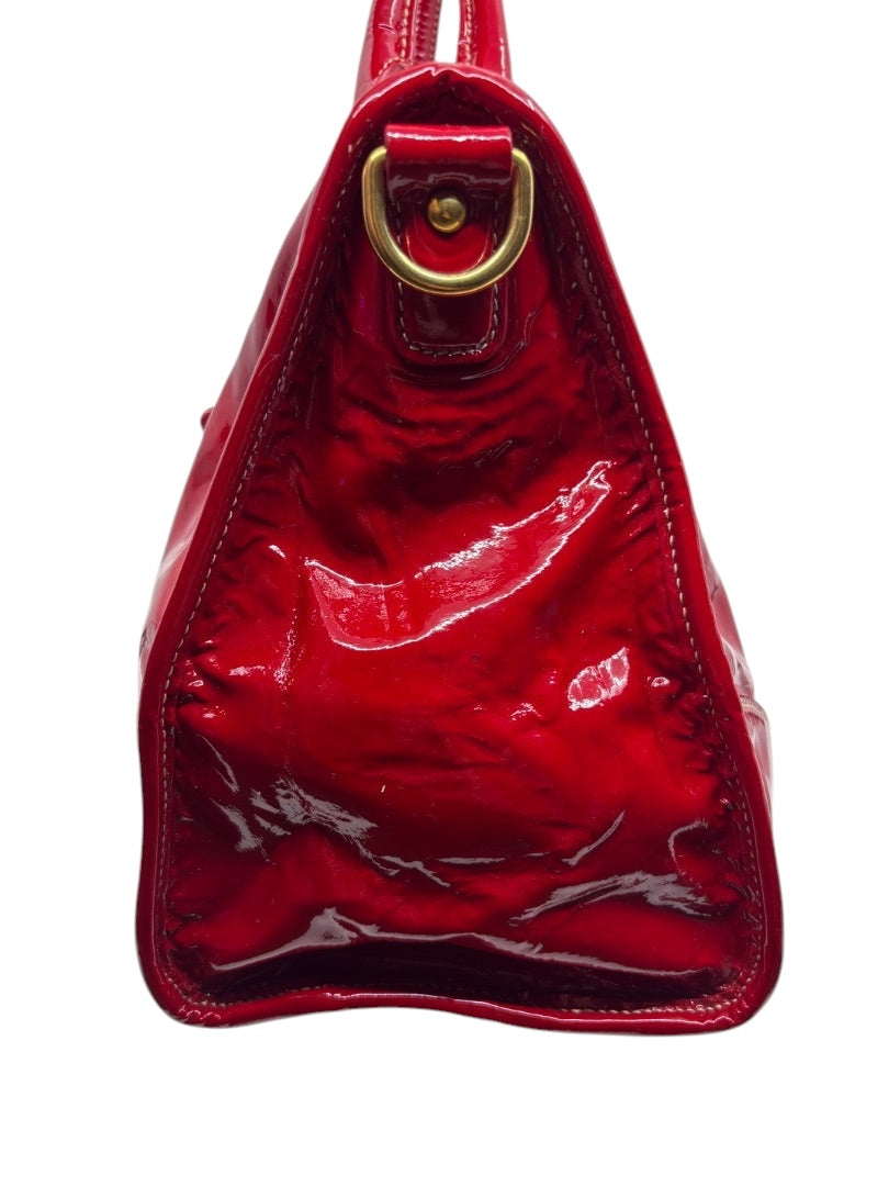 Side view of a red Prada Vernice patent leather shoulder bag with gold hardware from Posh Purse Co.