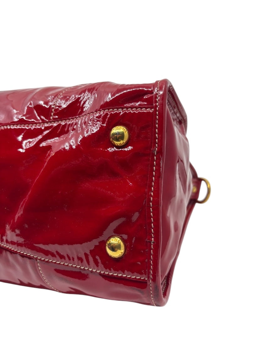Posh Purse Co. red Prada Vernice patent leather shoulder bag with gold-tone hardware and contrast stitching.
