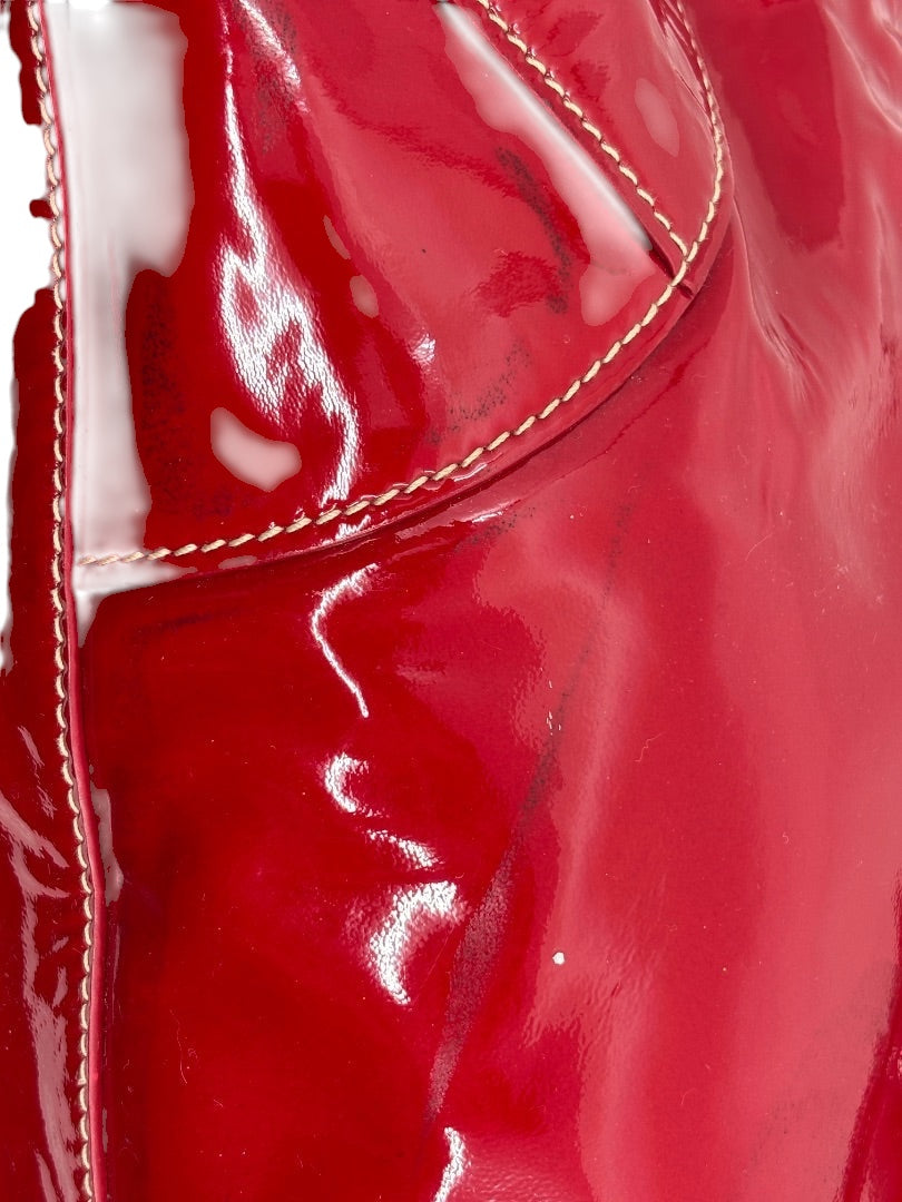 Close-up of a red patent leather Prada Vernice shoulder bag with contrast stitching from Posh Purse Co.
