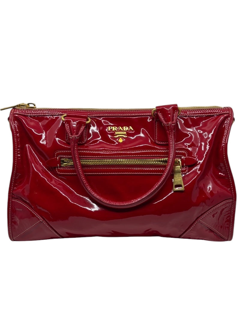 Posh Purse Co. red Prada Vernice patent leather east/west shoulder bag with gold-tone hardware and front zip pocket.