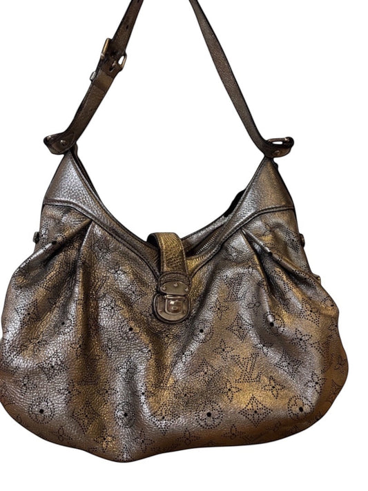 Posh Purse Co silver Louis Vuitton XS Mahina perforated leather crossbody bag with adjustable strap and zip closure.