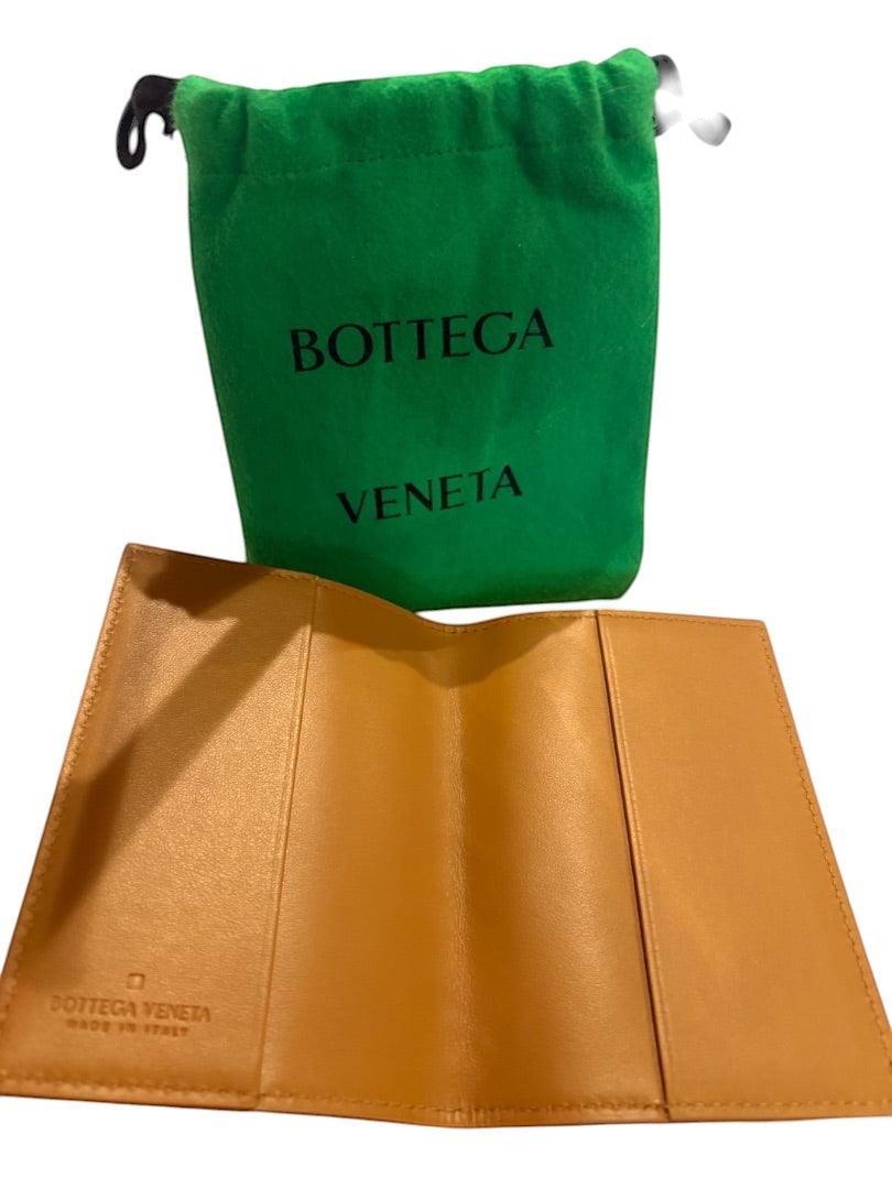 Posh Purse Co tan leather Bottega Veneta passport holder with iconic Intrecciato weave and green dust bag.
