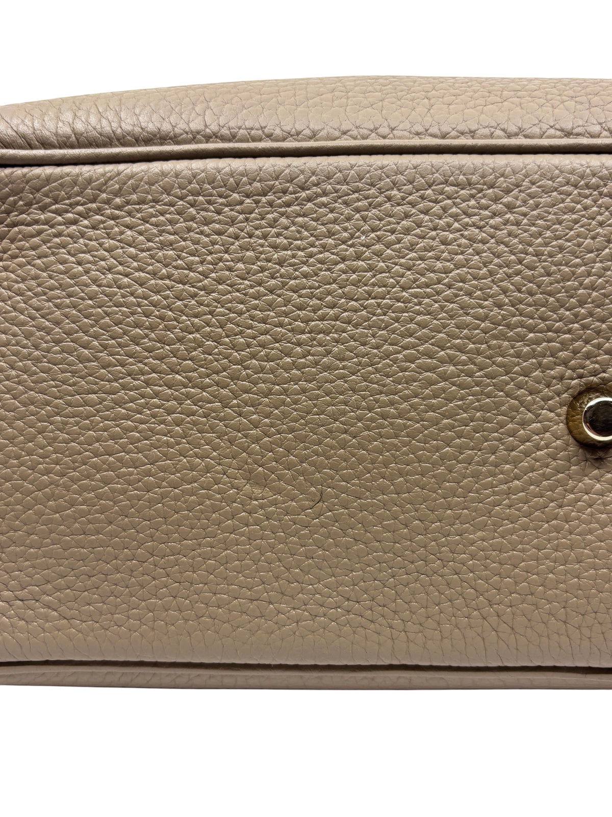 Close-up of Posh Purse Co. tan Dior Diorissimo leather tote showing the textured grain and polished metal hardware.