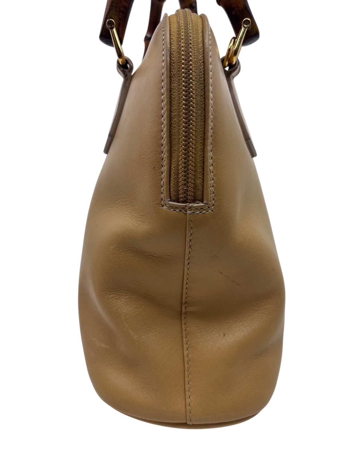 Side view of a preloved tan leather Gucci handbag with iconic bamboo handle detailing from Posh Purse Co