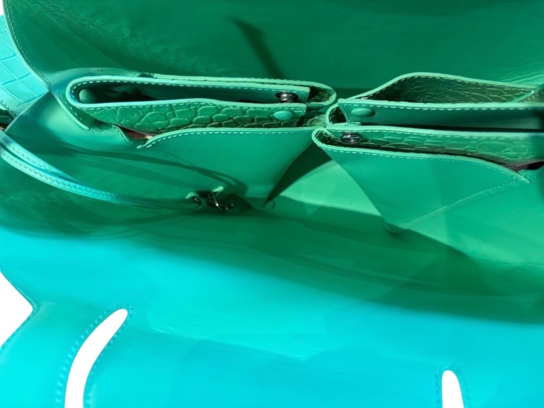 Posh Purse Co teal croc embossed doll bag with interior pockets and snap closures.