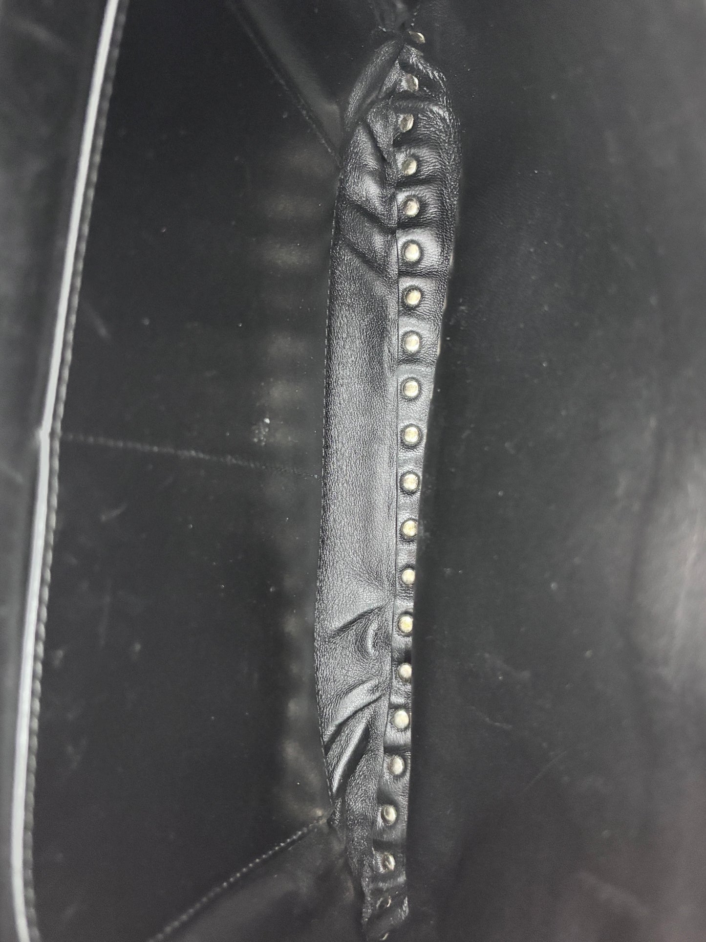 Interior of Posh Purse Co. preloved black Valentino Rockstud bag showing leather lining and signature stud detail
