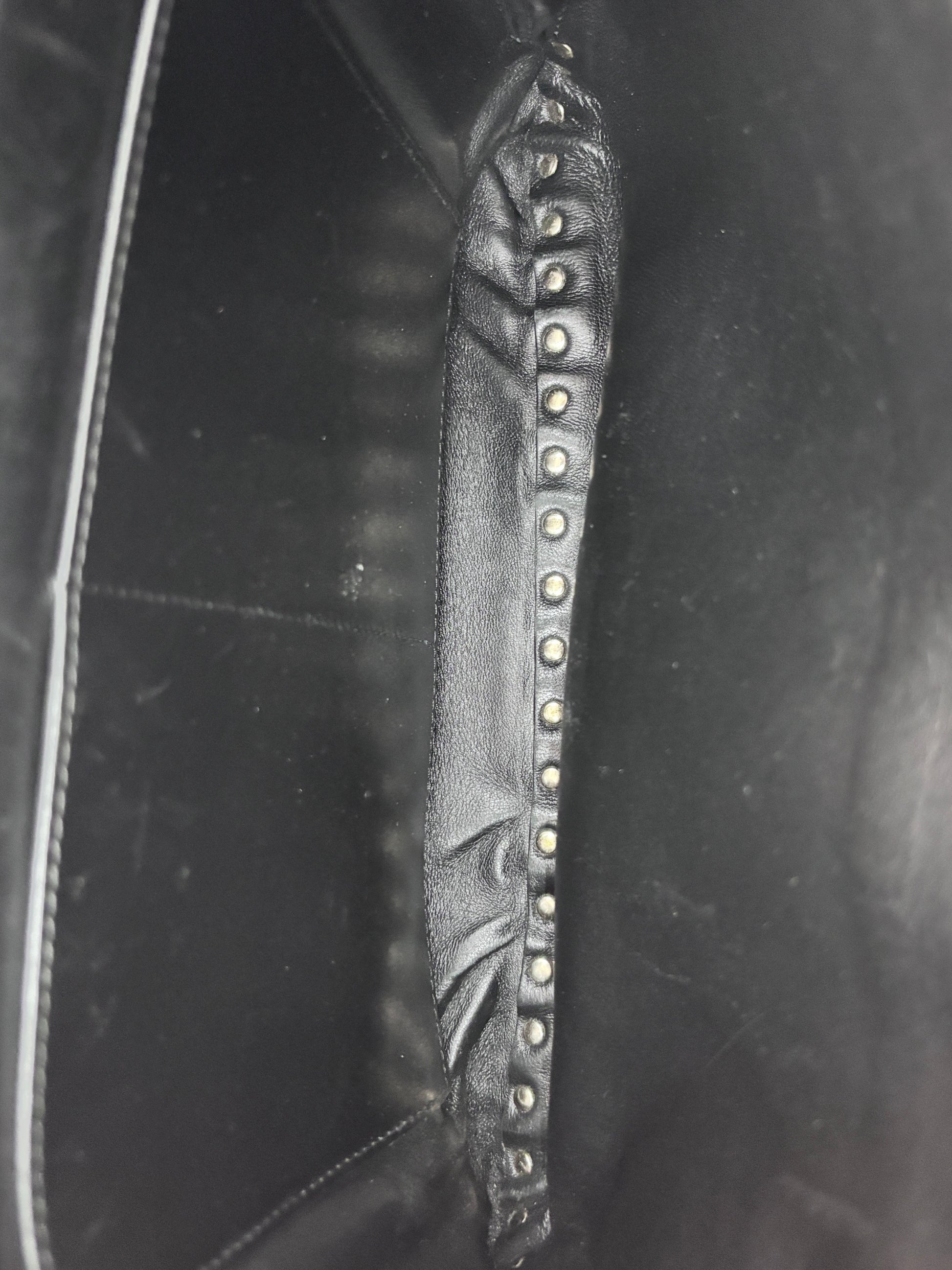 Interior of Posh Purse Co. preloved black Valentino Rockstud bag showing leather lining and signature stud detail