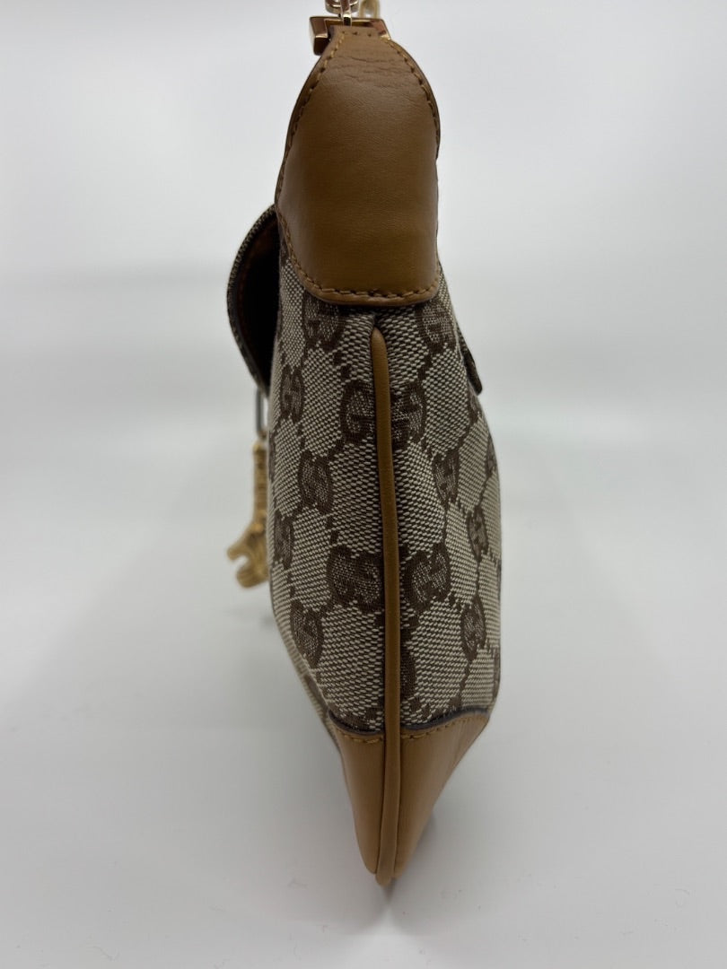 Side view of a rare vintage Gucci GG monogram canvas shoulder bag with tan leather trim from Posh Purse Co.