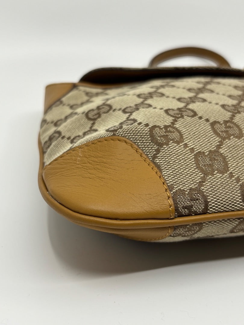 Posh Purse Co. vintage Gucci GG monogram canvas shoulder bag with tan leather trim and tiger head detail.