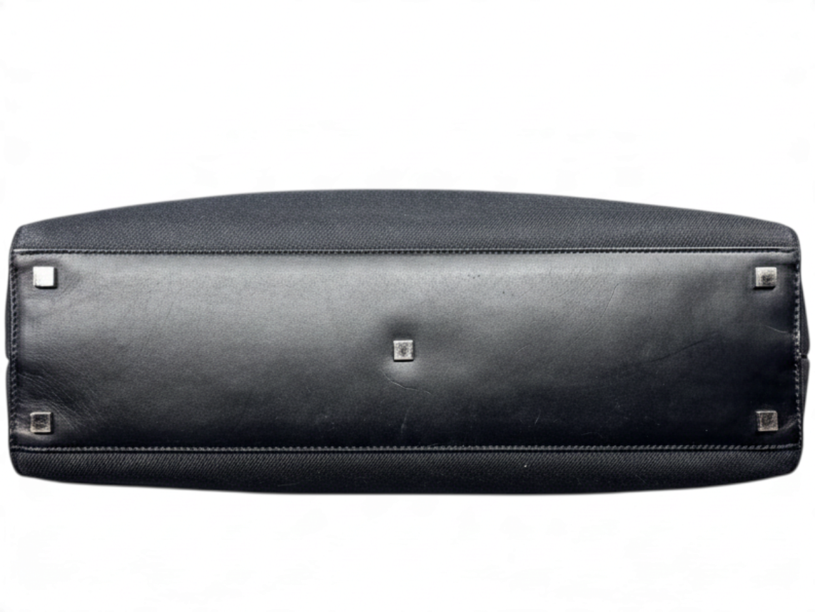Bottom view of a vintage black Gucci shopper tote bag with protective metal feet, sold by Posh Purse Co.